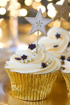 Golden cupcakes against a background of defocused fairy lights
