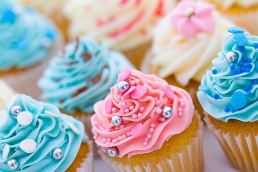 Assortment of pastel colored cupcakes