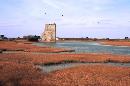 an isolated castle in the irish country side beside a river