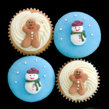 Christmas cupcakes isolated against a black background