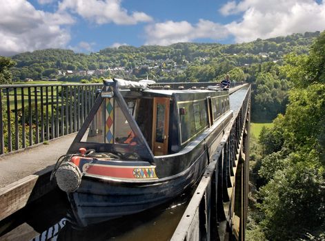 A narrowboat crossing the 120 foot high aqueduct on the Shropshire Union canal near Llangollan in Wales.