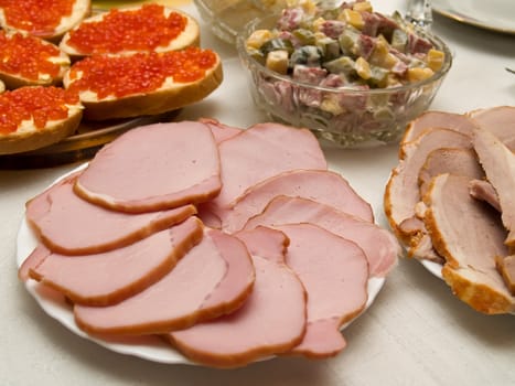 Table covered for a celebratory dinner. Sandwiches with red caviar.