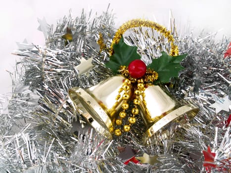 Christmas ornaments - bells on silver tinsel background