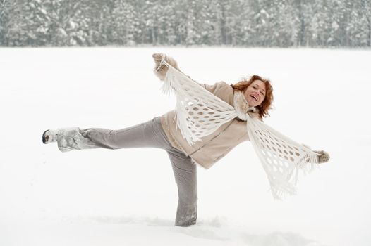 Attractive red-haired woman having fun in winters day.