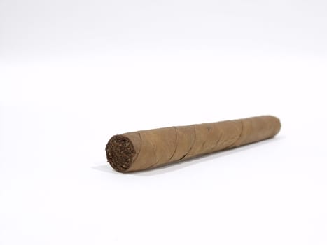 An isolated long wrapped cigar on a white surface