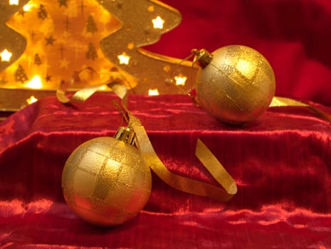 Christmas gold ornaments and gold with lamp like fir on the red background