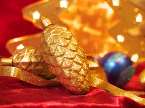 Christmas gold ornaments and gold with lamp like fir on the red background