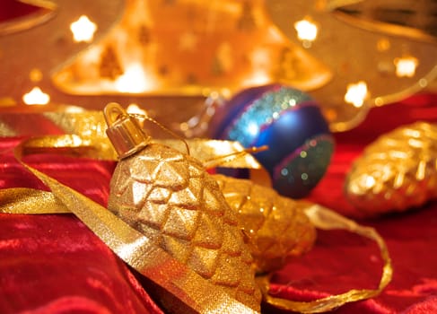 Christmas gold ornaments and gold with lamp like fir on the red background