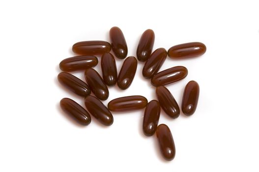 close up on stack of brown capsules, isolated on white