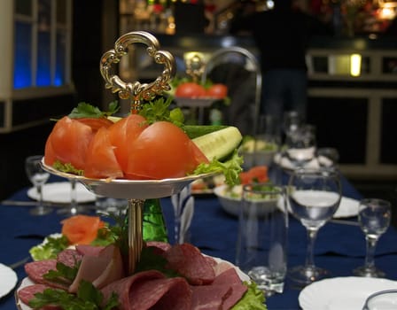 Vegetables and meat snack on a dining table