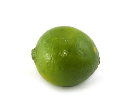 One green lime liyng on the white background