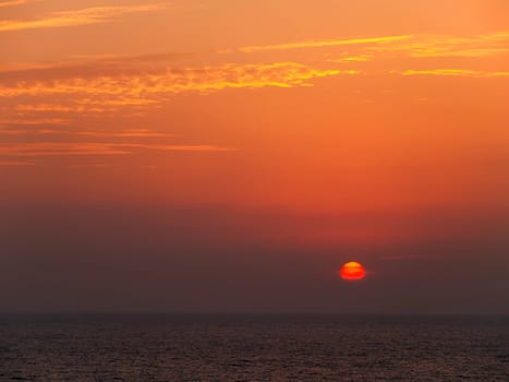 Vibrant orange and golden sunset in the sea