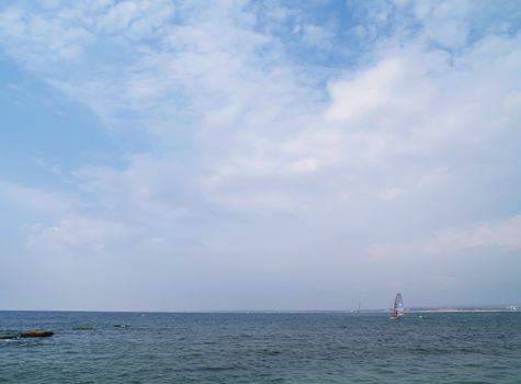 Sailing on calm blue water. Sailboat (yacht) cruising the ocean