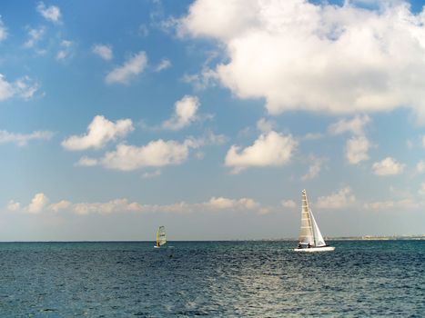 Sailing on calm blue water. Sailboat (yacht) cruising the ocean
