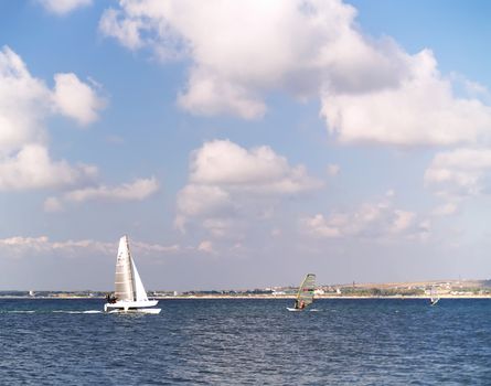 Sailing on calm blue water. Sailboat (yacht) cruising the ocean