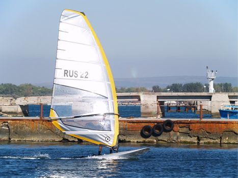 Sailing on calm blue water. Sailboat (yacht) cruising the ocean