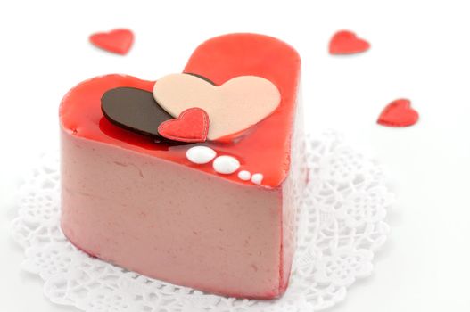 Valentine strawberry mousse cake with chocolate hearts on white background