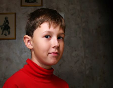 Smiling little boy in dark room