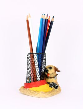 Black metal pencil cup filled with colorful used pencils, isolated