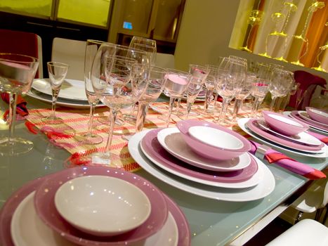 Table served on some persons. Set of glasses. Violet service