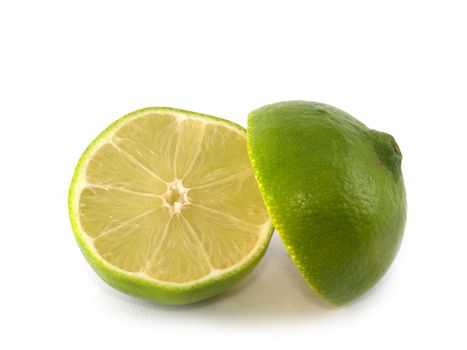 Two halves of  lime liyng on the white background