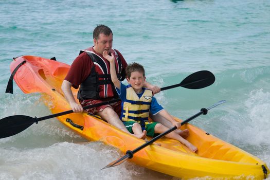 Father and son having fun on a kayak