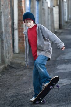 Boy skateboarding in an alleyway