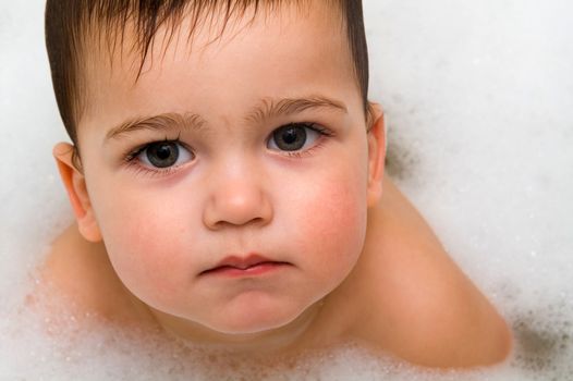 Close-up photo of serious boy in foam