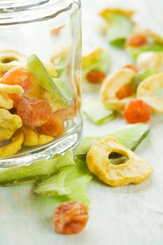 Assortment of sliced dried fruits in jar on table