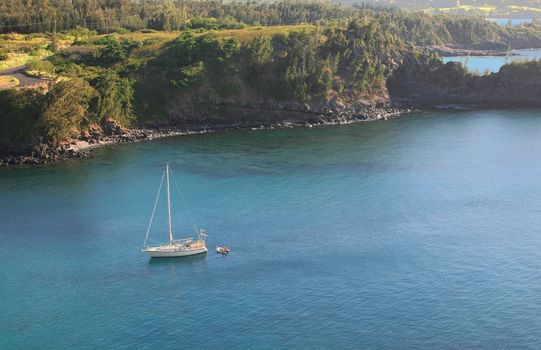 Honolua Bay with Sail Boat on crystal clear blue water in Maui Hawaii