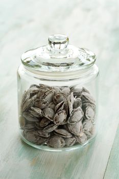 Some dried apricot stones and glass jar