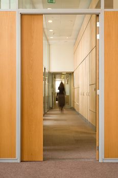 Woman silhouette in corridor of office building