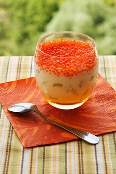 Red caviar with kefir sauce in glass