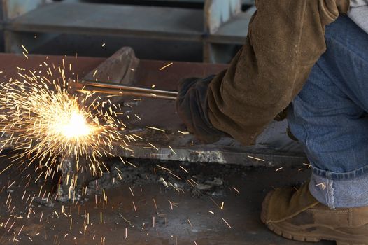 a shipyard steel worker burning steel