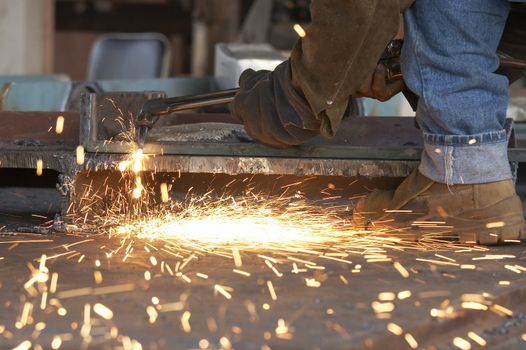 a shipyard steel worker burning steel