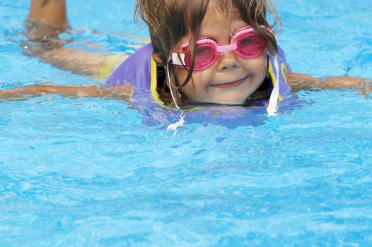 a young girl playing in pool