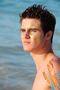 Portrait of young handsome caucasian model on the beach