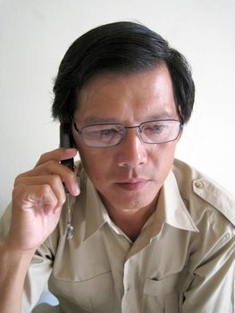 A business Asian man talking on phone