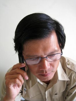 A business Asian man talking on phone