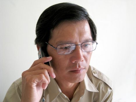 A business Asian man talking on phone