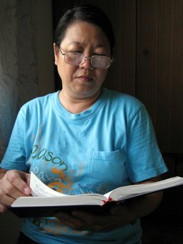 Asian woman is reading bible