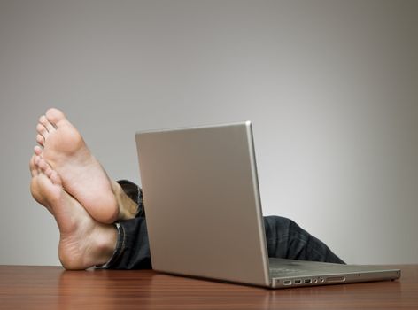 Lazy man in an office with a computer