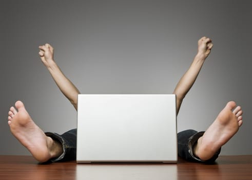 Happy man behind computer in an office