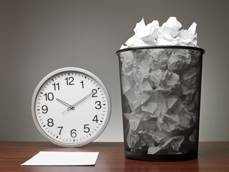 Recycle Bin and a clock in an office