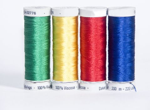 The image of four coils of Thread for a machine embroidery
