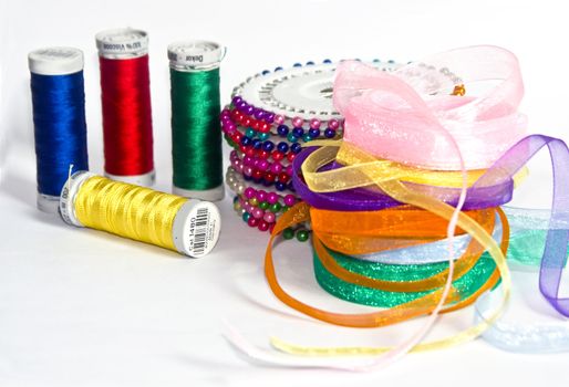 The image of strings for a machine embroidery pins and a decorative tape