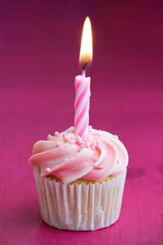 Mini cupcake decorated with a single birthday candle