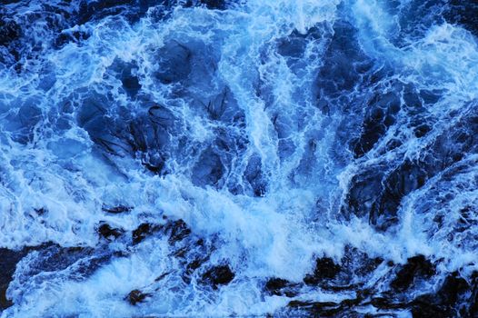 Close up of the foam of a breaking wave, suitable as a graphic background.