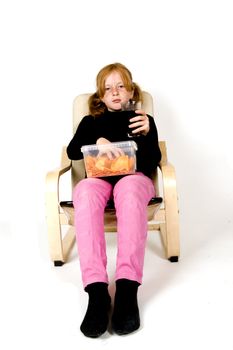 little girl is eating chips and drinking cola