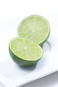 Fresh limes on white plate